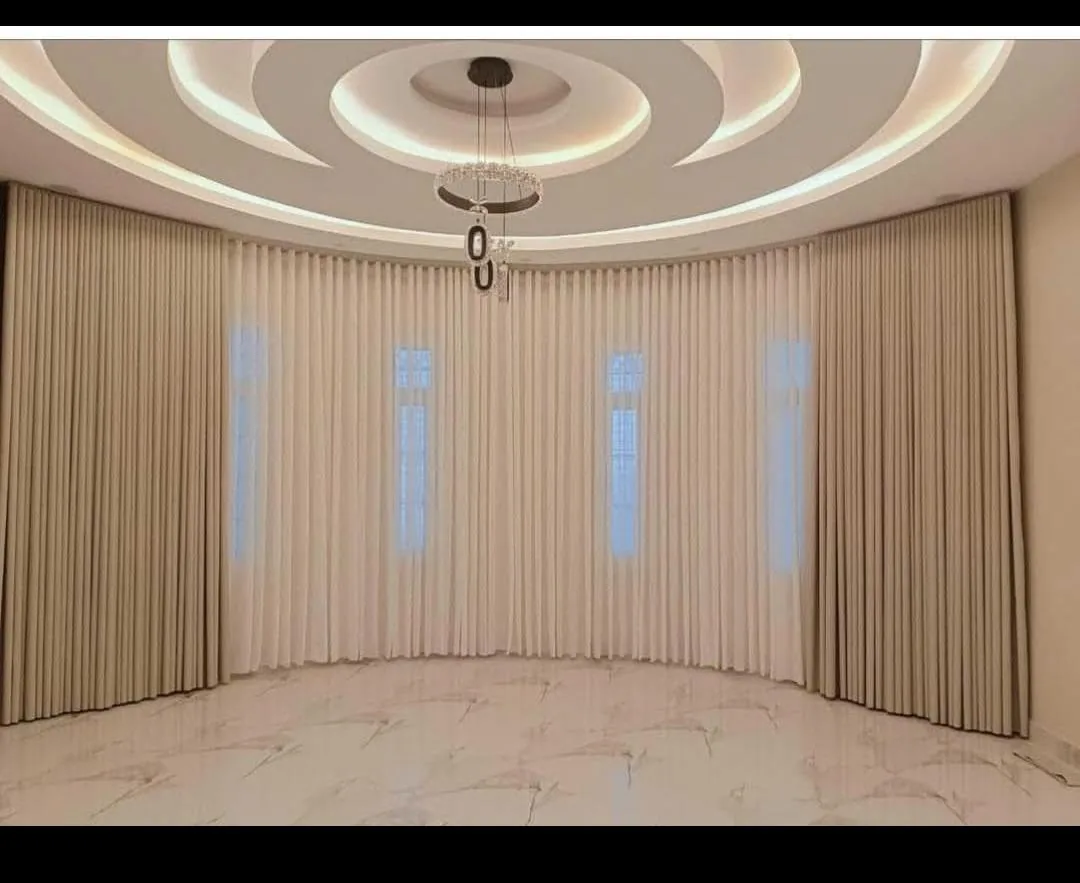 Grand hall with a curved wall of cream commercial curtains
